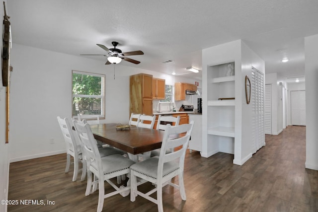 237 Riberia St, Saint Augustine, FL 32084 - dining area with baseboards, a ceiling fan, dark wood-style flooring, and built in shelves