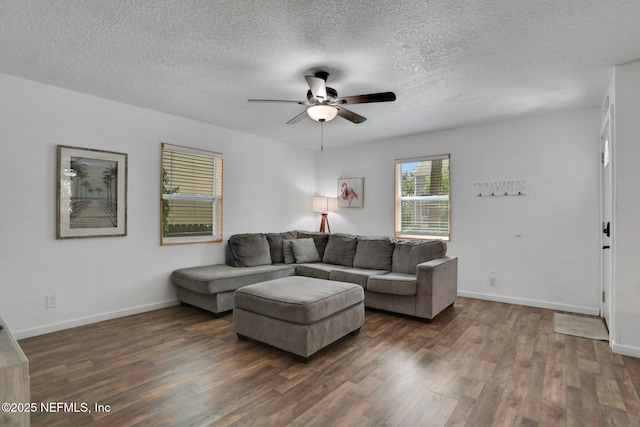 237 Riberia St, Saint Augustine, FL 32084 - living room featuring baseboards, a ceiling fan, dark wood-style flooring, and a textured ceiling