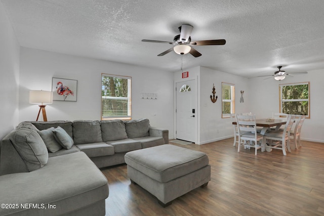 237 Riberia St, Saint Augustine, FL 32084 - living room featuring baseboards, a ceiling fan, a textured ceiling, and wood finished floors