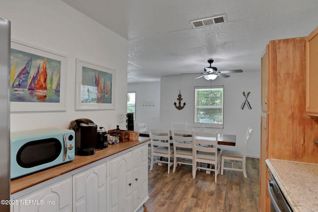 237 Riberia St, Saint Augustine, FL 32084 - dining area with a textured ceiling, a ceiling fan, wood finished floors, and visible vents