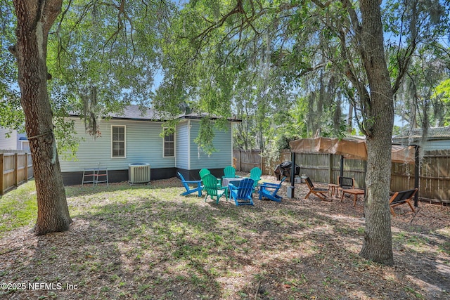 237 Riberia St, Saint Augustine, FL 32084 - view of yard featuring cooling unit, a fenced backyard, and an outdoor fire pit