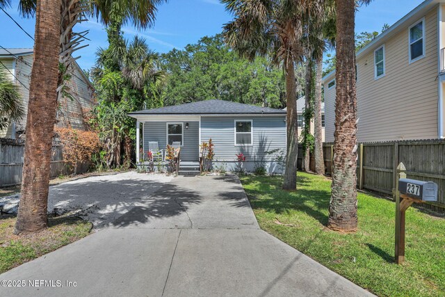237 Riberia St, Saint Augustine, FL 32084 - view of front of property featuring fence, a shingled roof, and a front lawn