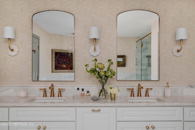 1478 Riverplace Blvd Unit 1008, Jacksonville, FL 32207 - bathroom with double vanity, a shower with shower door, and wallpapered walls