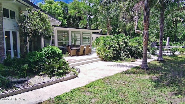 view of yard featuring a sunroom