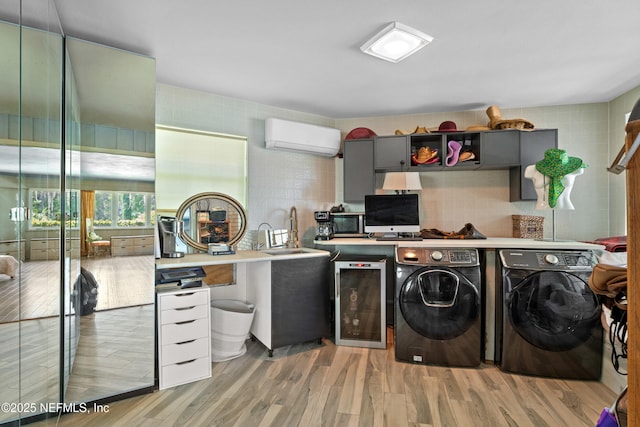 118 Herja Acre Ln, Palatka, FL 32177 - laundry room featuring washing machine and dryer, a wall mounted air conditioner, wine cooler, and light wood-style flooring