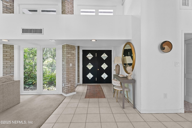 118 Herja Acre Ln, Palatka, FL 32177 - entrance foyer with a high ceiling, light tile patterned flooring, baseboards, and light colored carpet