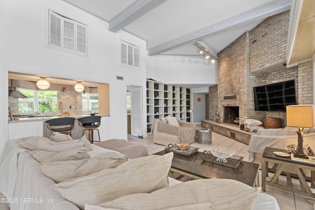 118 Herja Acre Ln, Palatka, FL 32177 - living room with tile patterned flooring, a towering ceiling, a fireplace, beam ceiling, and brick wall