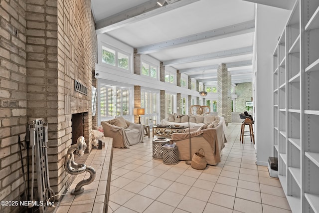118 Herja Acre Ln, Palatka, FL 32177 - living room featuring beam ceiling, light tile patterned flooring, a brick fireplace, and healthy amount of natural light