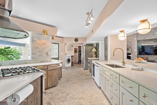 118 Herja Acre Ln, Palatka, FL 32177 - kitchen featuring washer / clothes dryer, a sink, appliances with stainless steel finishes, wall chimney exhaust hood, and light countertops