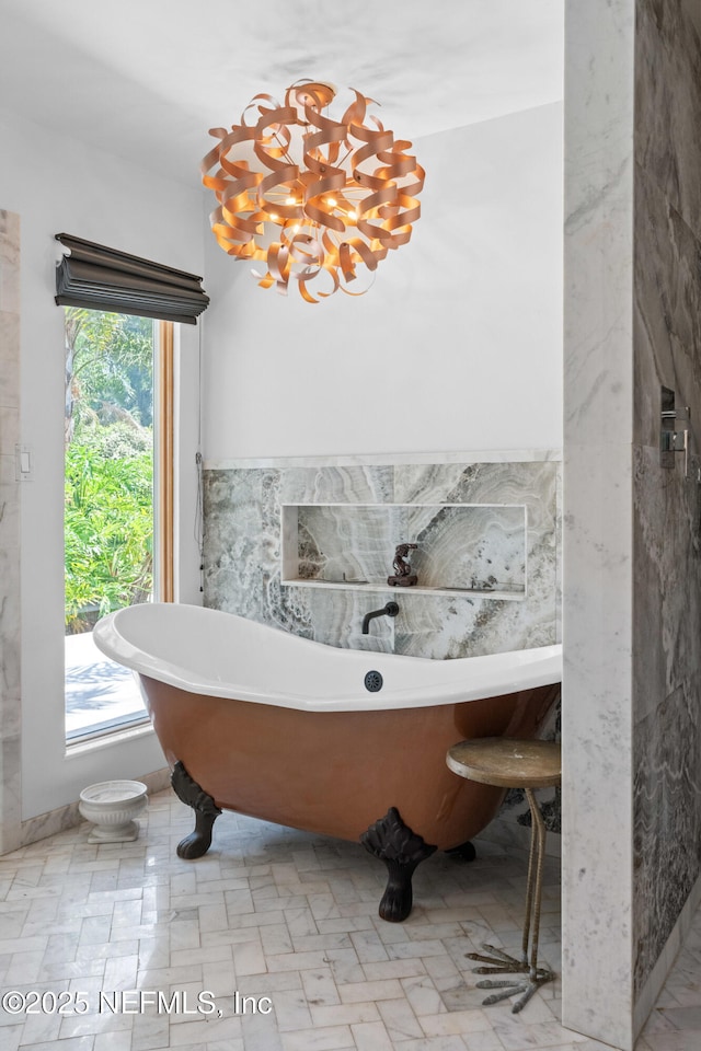 118 Herja Acre Ln, Palatka, FL 32177 - bathroom featuring a freestanding tub and a chandelier