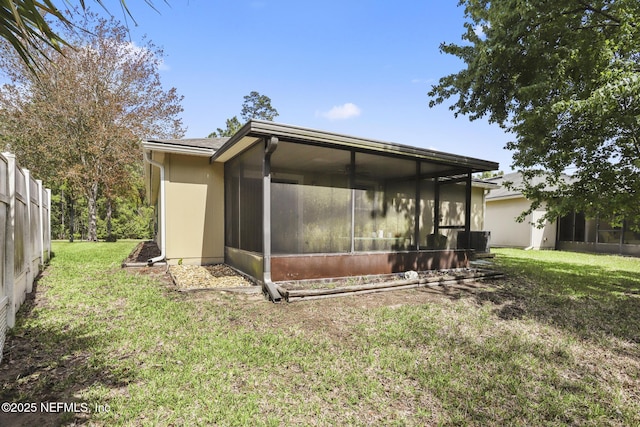 217 N Twin Maple Rd, Saint Augustine, FL 32084 - back of house with central AC, a yard, and a sunroom