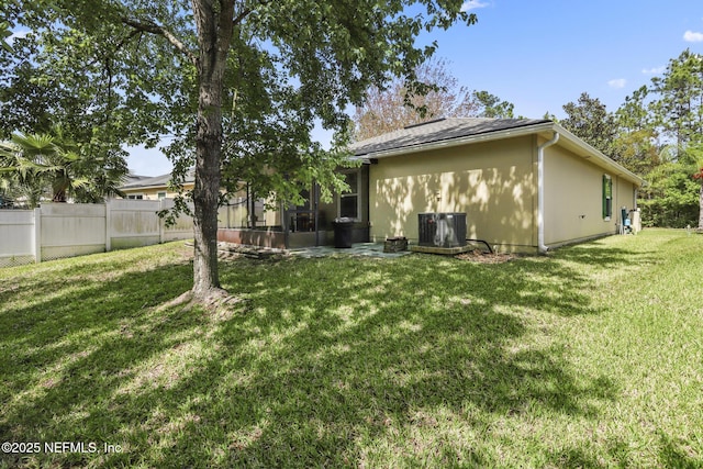 217 N Twin Maple Rd, Saint Augustine, FL 32084 - back of property with fence, a yard, central AC unit, and a sunroom