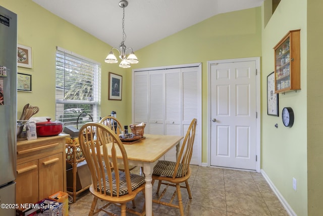 217 N Twin Maple Rd, Saint Augustine, FL 32084 - dining area with baseboards, light tile patterned floors, an inviting chandelier, and lofted ceiling