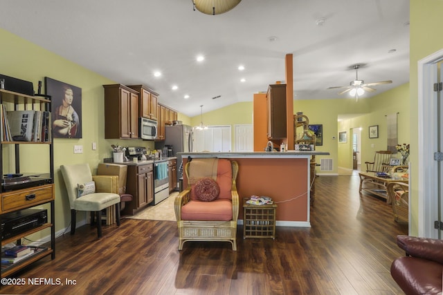 217 N Twin Maple Rd, Saint Augustine, FL 32084 - living room featuring a ceiling fan, visible vents, lofted ceiling, and dark wood-type flooring