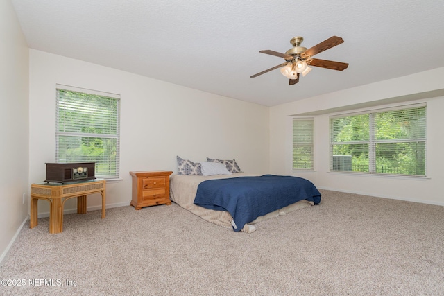 4917 Cypress Links Blvd, Elkton, FL 32033 - carpeted bedroom with multiple windows, baseboards, and ceiling fan