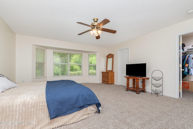 4917 Cypress Links Blvd, Elkton, FL 32033 - carpeted bedroom featuring a walk in closet, ceiling fan, a closet, and baseboards