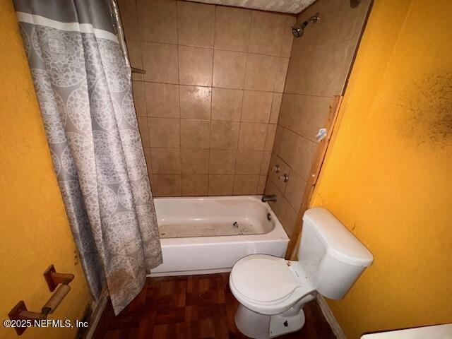 bathroom with toilet and shower / bath combo