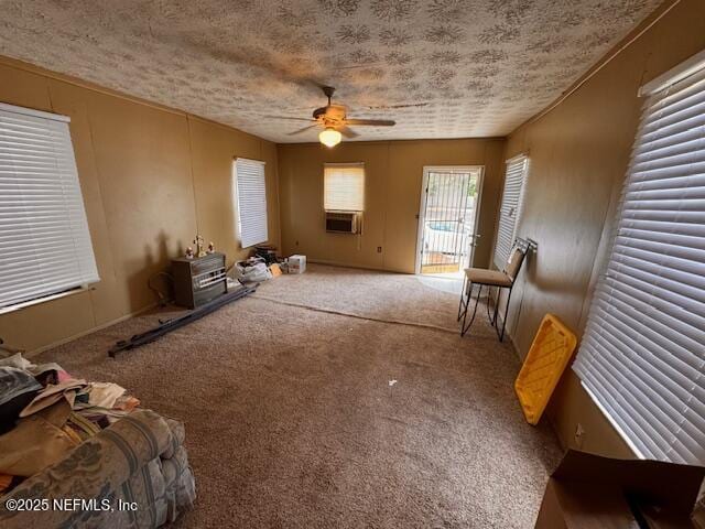 carpeted living area featuring a textured ceiling, a ceiling fan, and cooling unit