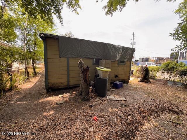 view of outbuilding with fence