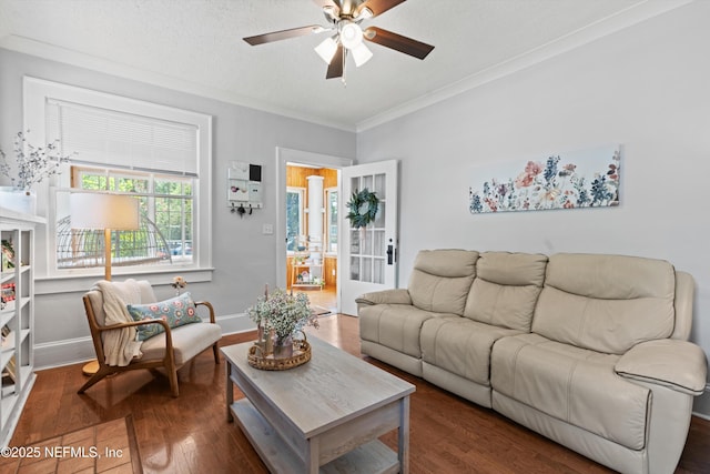 living area with crown molding, baseboards, ceiling fan, and wood finished floors