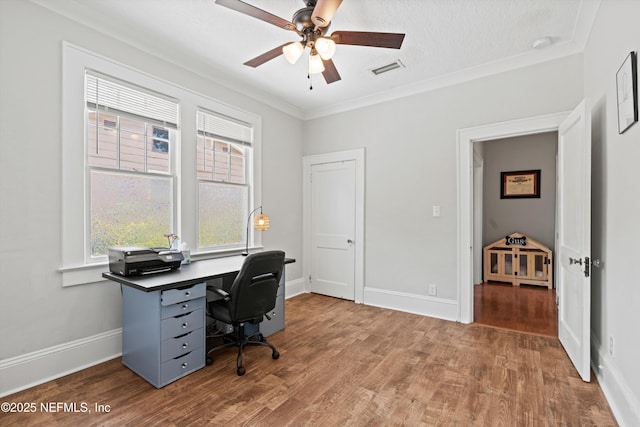 home office featuring crown molding, baseboards, ceiling fan, and wood finished floors