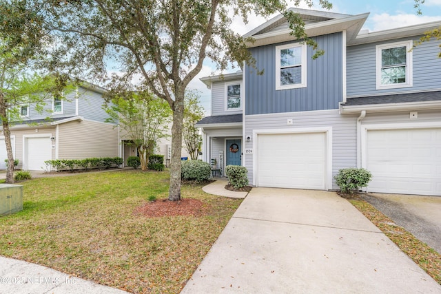 multi unit property with a front lawn, concrete driveway, and an attached garage