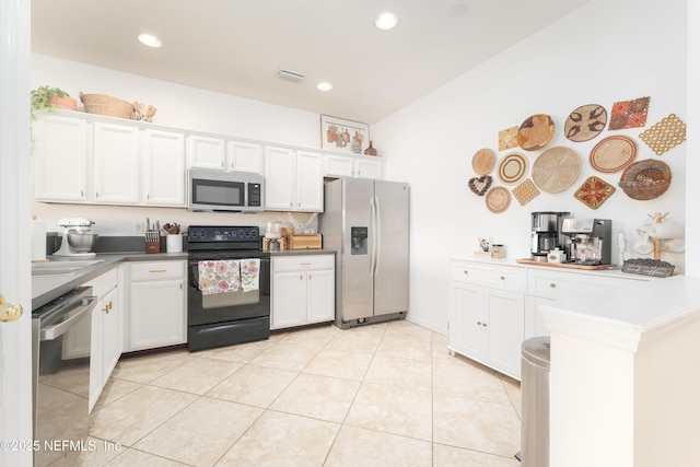 kitchen with light tile patterned floors, visible vents, stainless steel appliances, and white cabinetry