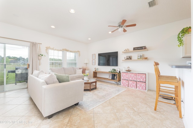 living area featuring recessed lighting, light tile patterned flooring, ceiling fan, and visible vents