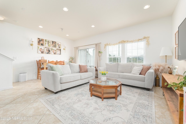 living room with recessed lighting, light tile patterned flooring, and a healthy amount of sunlight