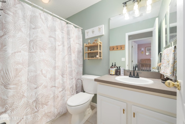 bathroom with tile patterned floors, toilet, and vanity