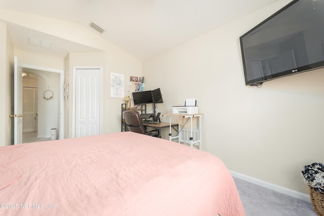 carpeted bedroom with a closet, visible vents, lofted ceiling, and baseboards