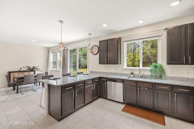 kitchen featuring stainless steel dishwasher, a sink, a peninsula, plenty of natural light, and recessed lighting