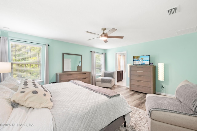 bedroom featuring wood finished floors, a ceiling fan, and baseboards