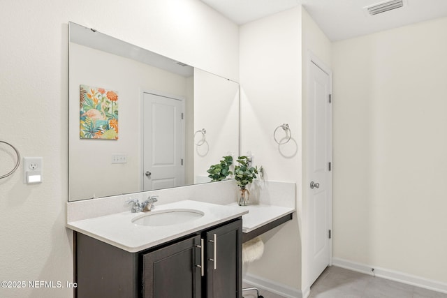 bathroom featuring vanity, baseboards, and tile patterned floors