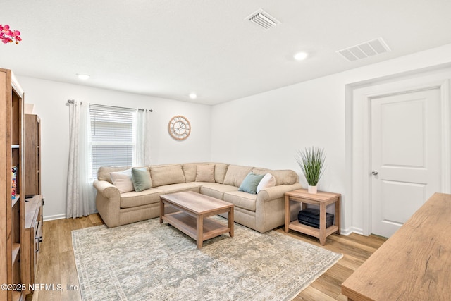living area featuring light wood-type flooring, recessed lighting, and baseboards