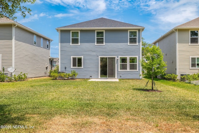 rear view of property with a lawn