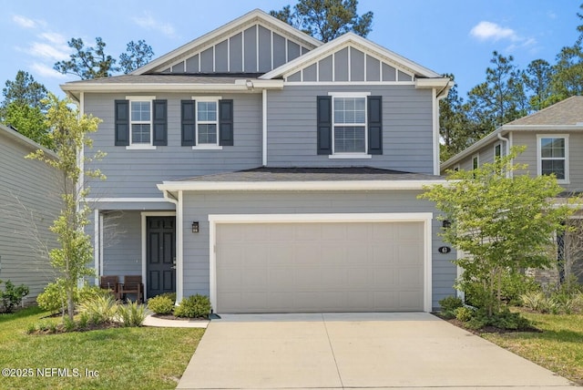view of front of property with board and batten siding, driveway, an attached garage, and a shingled roof