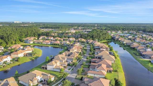 drone / aerial view featuring a residential view and a water view