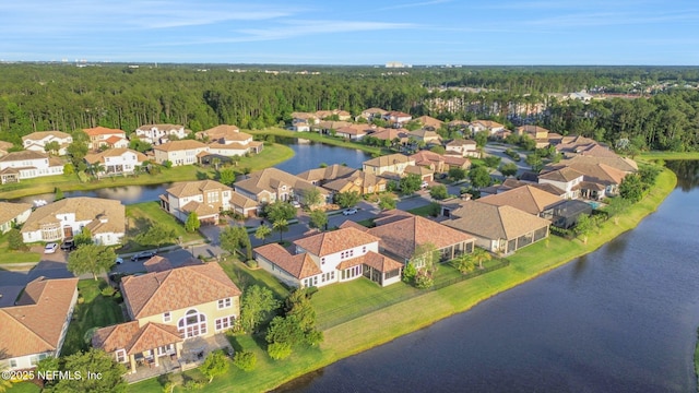 aerial view with a water view, a forest view, and a residential view