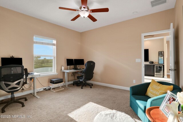 home office featuring a ceiling fan, carpet flooring, baseboards, and visible vents