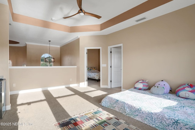 carpeted bedroom with visible vents, ceiling fan, crown molding, and baseboards