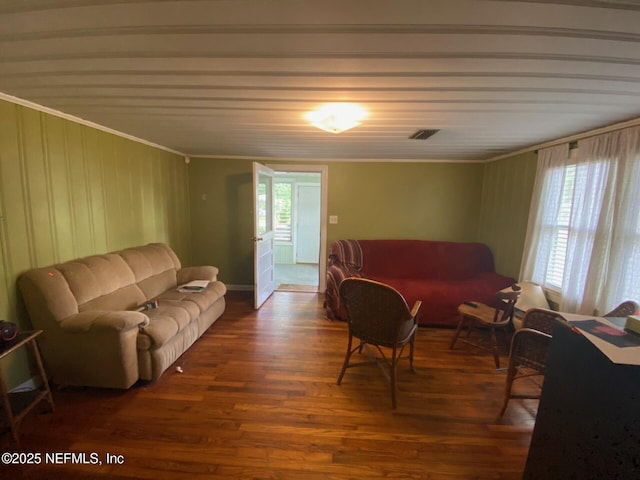 living room featuring crown molding, wood finished floors, and visible vents