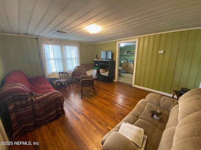 living area featuring wooden walls and wood finished floors
