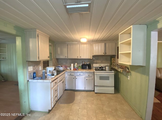kitchen featuring tile countertops, visible vents, tasteful backsplash, white range with electric stovetop, and white cabinetry