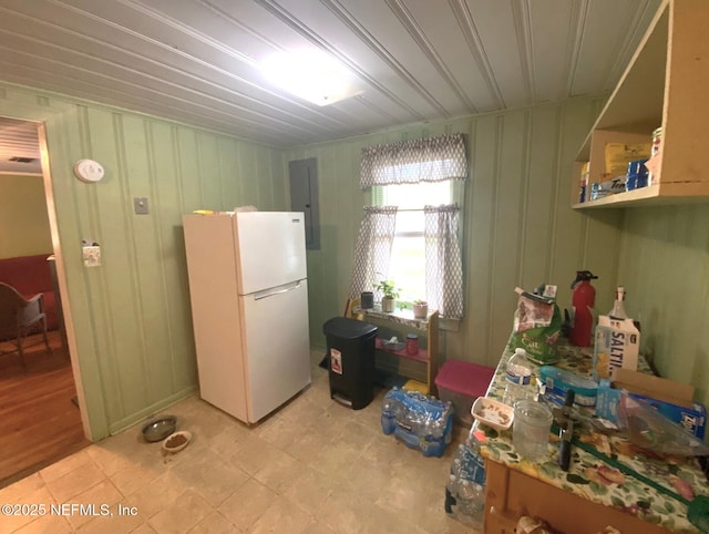 kitchen with freestanding refrigerator, open shelves, and electric panel