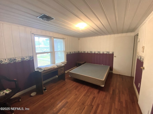 bedroom featuring visible vents and dark wood-type flooring