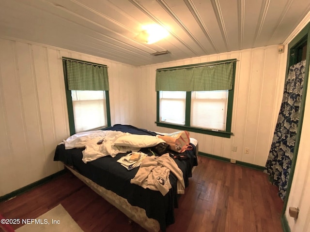 bedroom with dark wood-style floors