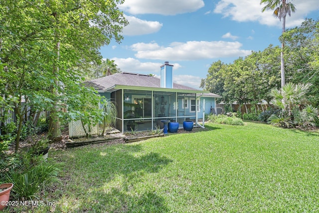 4518 Mountain Brook Ln E, Jacksonville, FL 32224 - rear view of house featuring roof with shingles, a sunroom, and a chimney