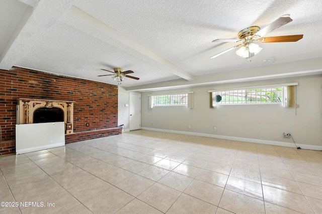 unfurnished living room with brick wall, light tile patterned flooring, baseboards, ceiling fan, and a textured ceiling