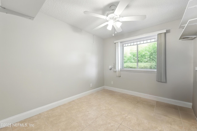 unfurnished room with baseboards, light tile patterned floors, a textured ceiling, and ceiling fan